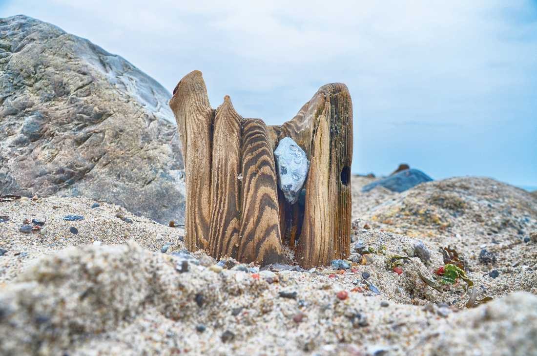 Irk Boockhoff, Verwittertes Holz am Strand 9 (Strand, Sand, Holz, verwittert, morbid, Kiesel, Steinchen, maritim, Fotokunst, Treppenhaus, Wohnzimmer, Badezimmer, Wunschgröße, bunt)