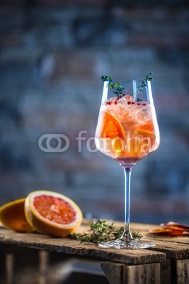 weyo, Cocktail drink on a old  wooden board. Alcoholic beverage with tropical fruits red pepper herb and ice (cocktail, cocktail, trinken, spritz, trinken, hintergrund, glas, bar, kalt, party, alkohol, obst, sommer, frisch, eis, getränke, alkoholiker, wodka, lemmon, pampelmusen, orange, minzen, grün, erfrischend, slice, kalk, weiß, tropisch, gin, saft, ro)