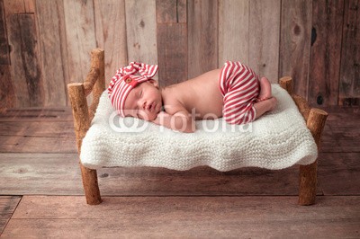 katrinaelena, Newborn Baby Boy Sleeping on a Tiny Bed (baby, neugeborene, junge, bett, schlafen, schlafen, portrait, kleinkinder, männlich, hübsch, süss, unschuld, unschuldig, einträchtig, beruhigt, person, noppen, atelieraufnahme, pyjamas, rot, weiß, gestreift, streif)