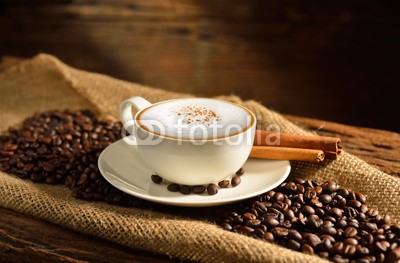 amenic181, A cup of cappuccino and coffee beans on old wooden background (kaffee, kaffee, cappuccino, cappuccino, latte, macchiato, koffein, tassen, schokolade, expressotasse, bohne, aroma, bohne, braun, trinken, sackleinen, frÃ¼hstÃ¼cken, zimt, getrÃ¤nke, schaum, mug, holz, auf, morgens, close-up, sahne, jahrgang, schwar)