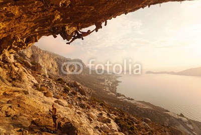 Andrey Bandurenko, Rock climber at sunset, Kalymnos Island, Greece (bergsteiger, klettern, fels, sichern, klettern, seil, sonnenuntergänge, paar, aktiv, betätigung, wölben, cave, herausforderung, felsen, schwer, abend, extrem, griechenland, guy, höhe, hoch, insel, landschaft, blei, lebensstil, männlich, mann, ber)