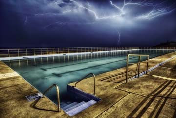 Dee Kramer, Shellharbour Pool Strike (Pool, Swimming Pool, Abendszene, Unwetter, Blitze, Australien, Fotokunst, Wunschgröße, Wohnzimmer, Treppenhaus, bunt)