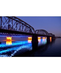 Hady Khandani, ILLUMINATED SINO-KOREAN FRIENDSHIP BRIDGE OVER YALU RIVER BETWEEN CHINA AND NORTH KOREA - DANDONG - BLUE