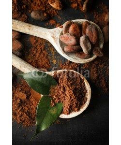 Africa Studio, Spoon with aromatic cocoa powder and green leaf on scratched wooden background, close up