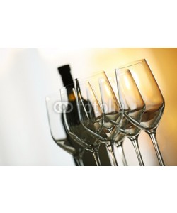 Africa Studio, Empty wineglasses in a row and bottle on a table, close up