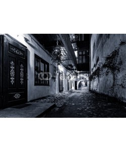 mandritoiu, Moody monochrome view of a cobblestone street passage in the old city center of Sibiu, Romania