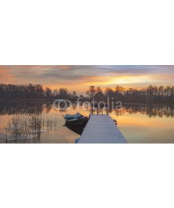 Mike Mareen, boat moored to the snow-covered bridge over the lake in winter m