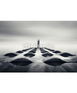 farizun amrod, businessman standing on pipeline at beach