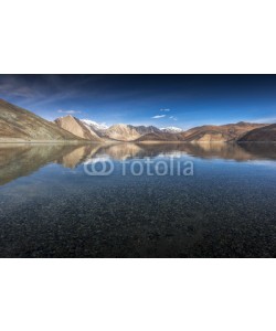 Sakrapee Nopparat, Reflection of Mountains on Pangong Lake with blue sky background. Leh, Ladakh, India.