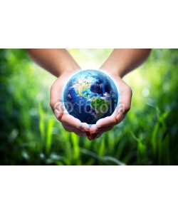 Romolo Tavani, earth in hands - grass background - environment concept