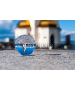 bychykhin, Glass transparent ball on church background and grainy surface