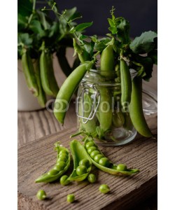 fotoatelie, Ripe Green peas on wooden table.