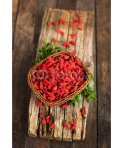 pilipphoto, Goji berries in the basket on the rustic table