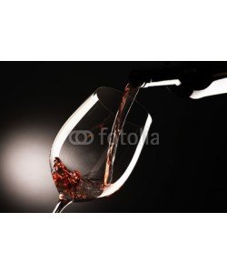 MAURO, glass with red wine on dark background