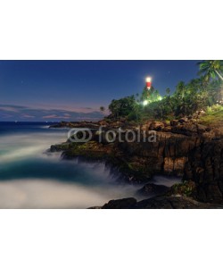 Viktar, Colorful sunset at the Kovalam beach, Kerala, India. Lighthouse view. Long exposure.