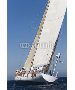 biker3, Group of crew members sitting on the side of a sailboat in the ocean