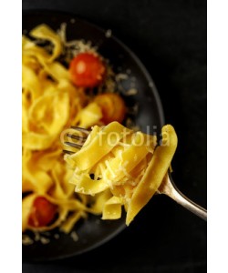 fotoatelie, Fettuccini pasta with cherry tomatoes and bacon on a fork