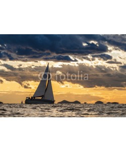Pavel, Sailing boat on open sea with dramatic clouds and small islands in background