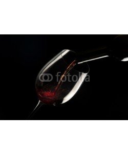 MAURO, glass with red wine on black background