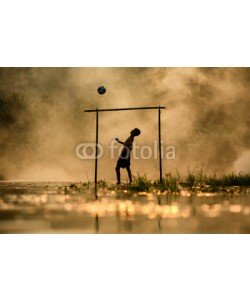 sutiporn, Soccer The boy silhouette  playing football in the river Thailand and Laos
