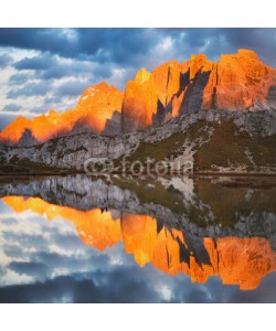 Viktar, Evening on Laghi dei Piani (Lakes Piano) with mountains in sunlit reflected in smooth surface lake water, Southern Tyrol, Dolomites, Tre Cime di Lavaredo National Park, Italy. Enrosadira.