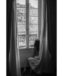 Tetiana, Morning in Rome. Naked girl sitting near a large window wrapped in a curtain, black and white photo