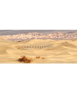 David Smith, rolling sand dunes with mountains in death valley california at