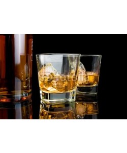 donfiore, whiskey with ice in glasses near bottle on black background