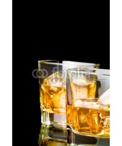 donfiore, whiskey with ice in glasses on black background