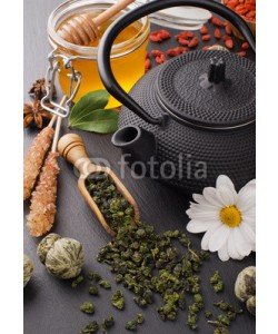 andriigorulko, still life with green tea and honey over black stone