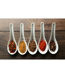 Africa Studio, Different kinds of spices in ceramics spoons, close-up,