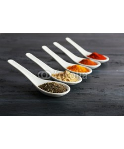 Africa Studio, Different kinds of spices in spoons on wooden background