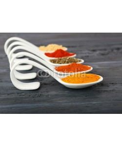 Africa Studio, Different kinds of spices in spoons on wooden background