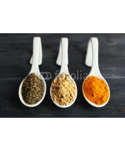 Africa Studio, Different kinds of spices in spoons on wooden background