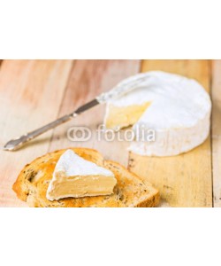 -Marcus-, Camembert cheese with cut wedge on toasted bread slice and vinta