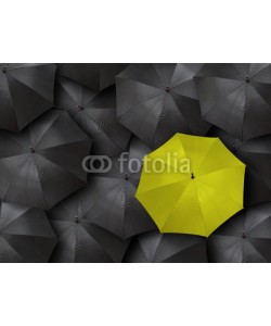 chones, concept for leadership with many blacks and yellow umbrella