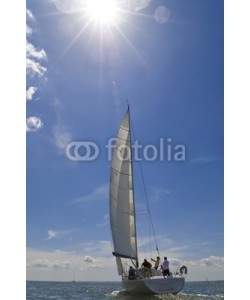 Darren Baker, A yacht sailing on a bright sunny summer day