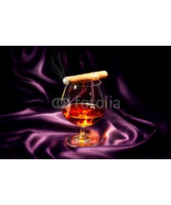 Subbotina Anna, Cognac and cigar. Glass of brandy over dark background