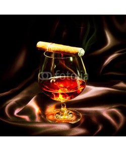Subbotina Anna, Cognac and cigar. Glass of brandy over dark background