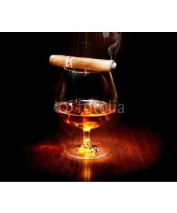 Subbotina Anna, Cognac and cigar. Glass of brandy over dark background